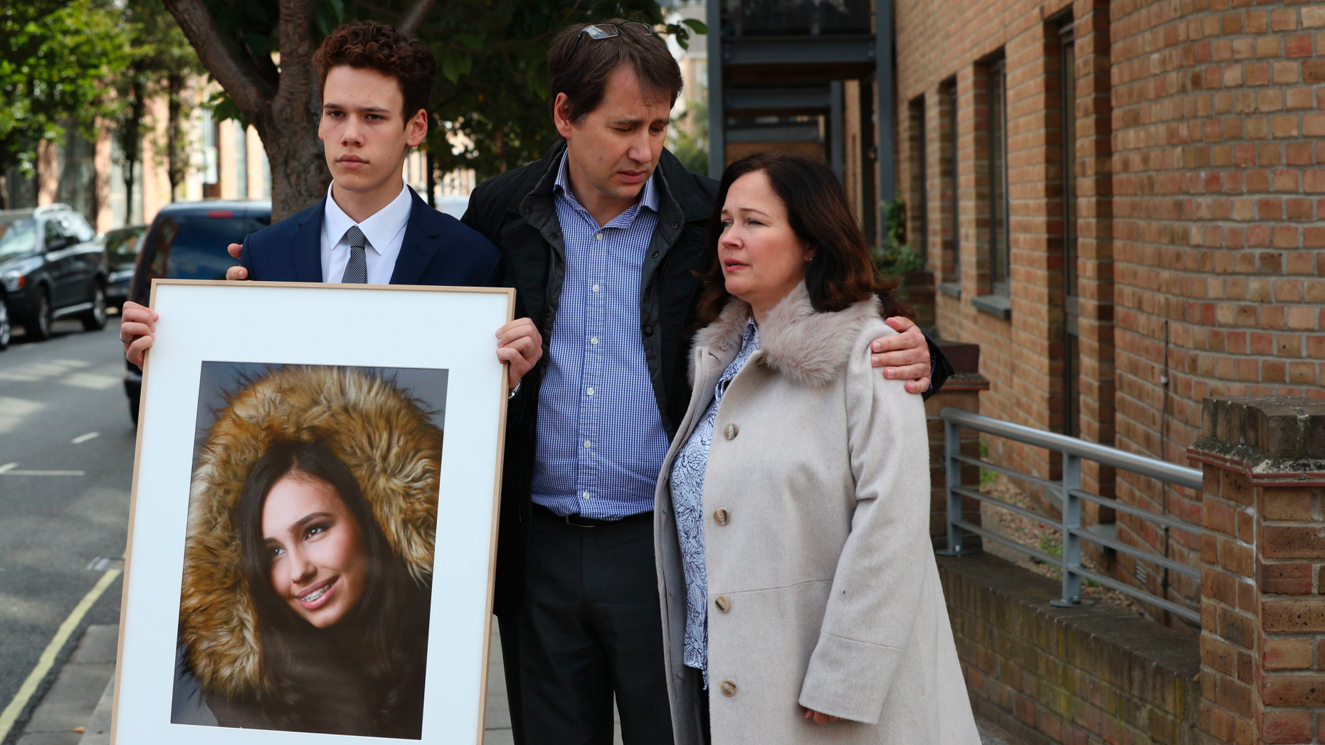 Nadim and Tanya Ednan-Laperouse, along with their son Alex, prepare to speak to the media in London's Coroners Court on Friday, September 28, 2018, following the death investigation. of 15 year old Natasha Ednan-Laperouse, appearing on the poster, who died after suffering a life-threatening allergic reaction during a flight from London to Nice after eating a sandwich ready to eat at the airport. Heathrow Airport. Natasha's father, Nadim, said Friday that he hoped the death of their daughter could serve as a turning point for making significant changes to the labeling of allergies on food packaging. (Jonathan Brady / PA via AP)