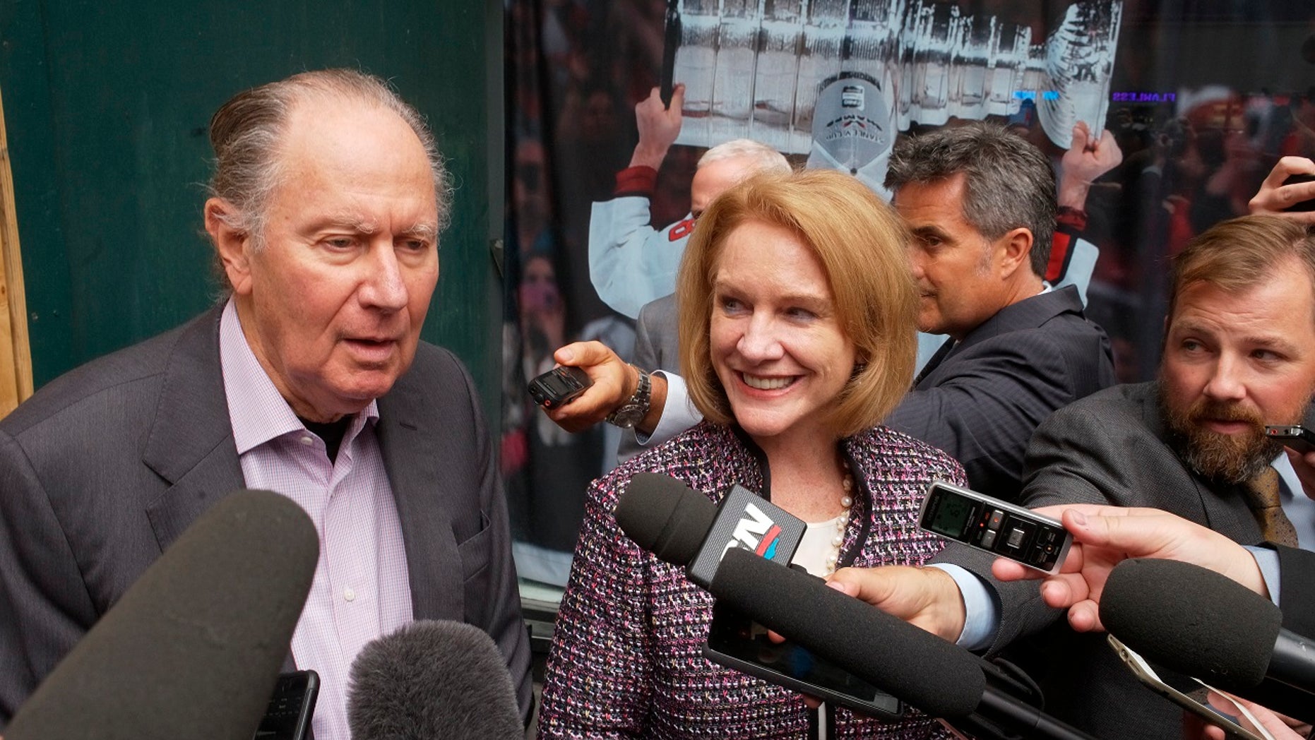 David Bonderman, left, of Seattle Hockey Partners, and Seattle Mayor Jenny Durkan talk to reporters as they leave a meeting at National Hockey League headquarters in New York City, Oct. 2, 2018.