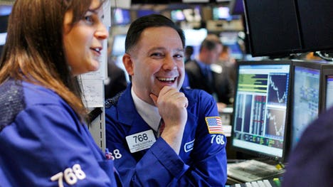 ' Rally Rolls On: The Dow rallied more than  points to close above the  mark for the first in history amid optimism the Fed will keep its foot firmly on the economic accelerator.