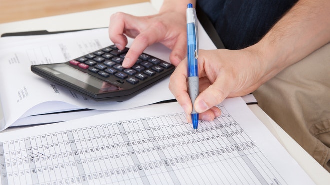 Couple calculating and planning expenses for retirement and budget