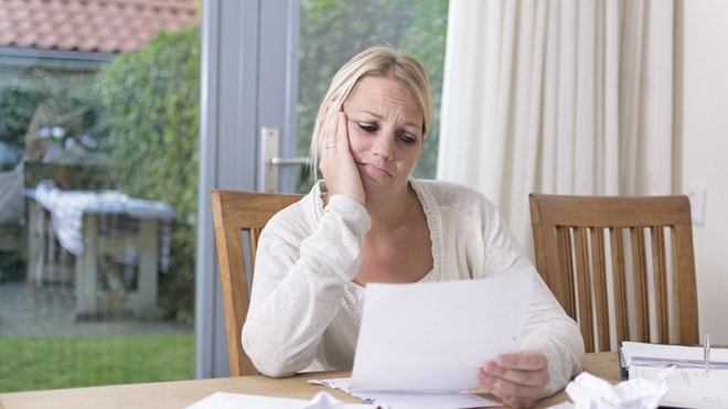 Stressed woman planning finances, bills, and debt