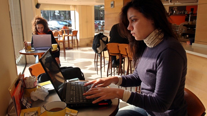 woman on laptop internet cafe