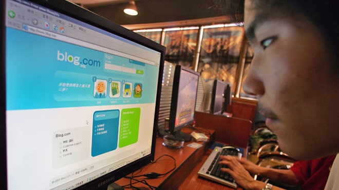 Man Blogging on Computer