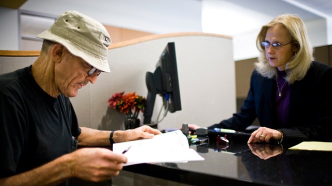 Elderly-Retired-Man-Talks-Investment-Advisor