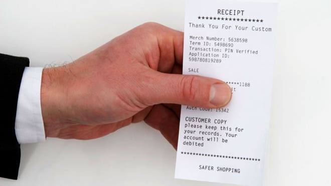 Man-Holding-Receipt-Purchase