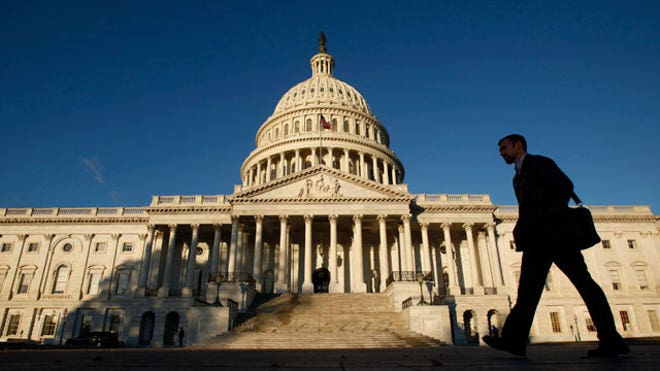 Man Walks by US Capitol Building FBN