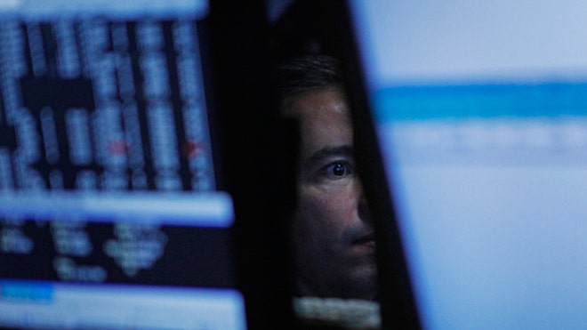 Stock Trader Surrounded by Monitors, Reuters