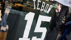 A federal judge ordered Reebok to temporarily stop manufacturing 'unauthorized' Tim Tebow apparel after Nike sued the Adidas unit earlier this week.