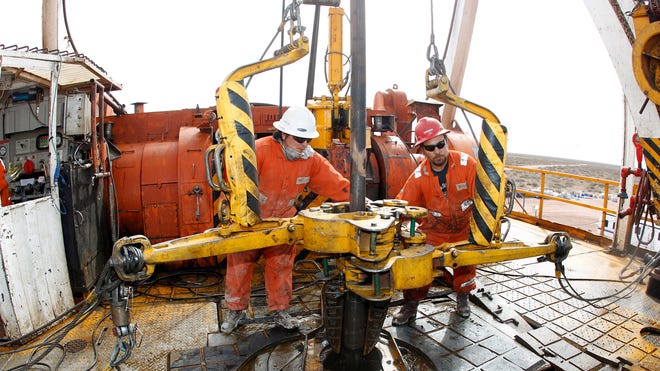 Oil Workers Operate Drill