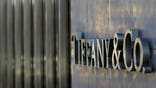 Tiffany cut its outlook after being ordered by a Dutch court to pay Swatch $ million over a dispute.