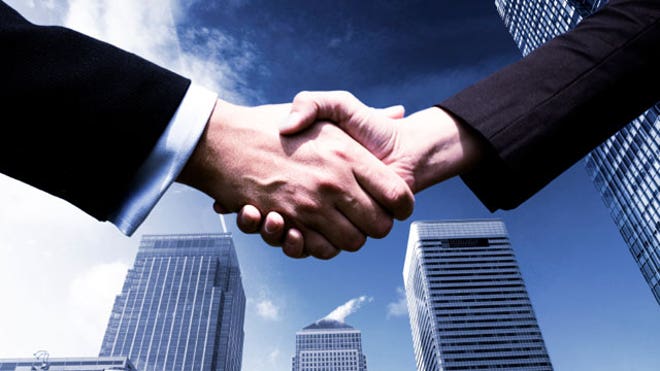 Handshake With City Skyline Background
