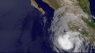 Hurricane Bud has weakened to a Category  storm in the Pacific as it approaches Mexico's coast.