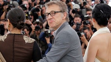Cristolph Waltz was rushed off the stage as chaos took over a live French television show when two loud bangs rang out in the audience.