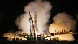 >A Soyuz capsule carrying three astronauts successfully docked with the International Space Station early Thursday, bringing the size of the crew at the orbiting outpost to six.