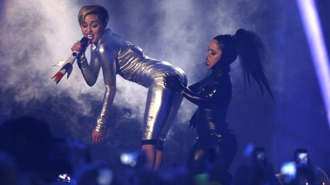 November 10, 2013: Miley Cyrus, left, and a dancer perform at the 2013 MTV Europe Music Awards in Amsterdam, Netherlands