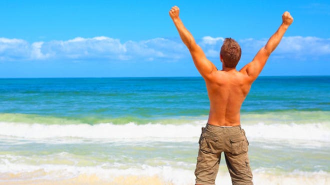 man celebrating beach