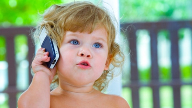 Toddler on cell phone iStock