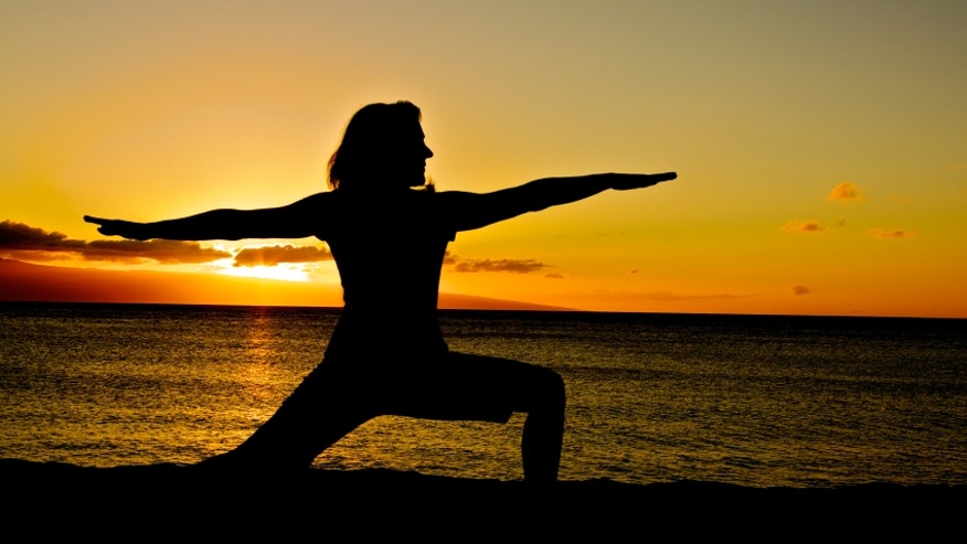 A sun salutation a day may keep the doctor away Yoga_warrior2_sunset_istock