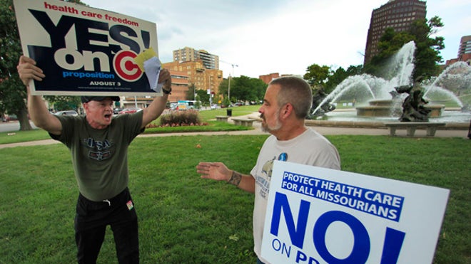 Mo. health law supporter/opponent w signs