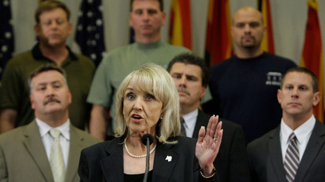 AZ Gov. Jan Brewer signs immigration law