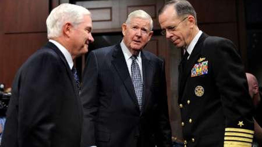 Rep. John Murtha flanked by Secretary Gates and Adm. Mike Mullen