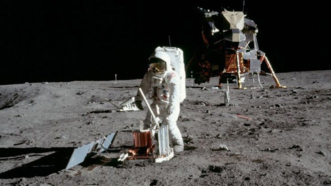 Buzz Aldrin deploys a seismometer on the moon