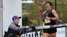 Erika Brannock was back at a marathon Saturday, smiling as she held up the tape for the winners.