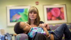 >In a small room similar to a doctor's office, Marlaina Dreher broke into applause as her 5-year-old son, Brandon, grabbed a red plastic spoon filled with pureed lasagna and fed himself.