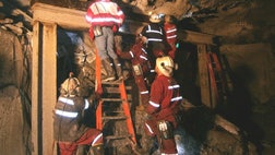 Rescuers searching for  trapped workers at a giant U.S.-owned gold and copper mine in Indonesia spotted six bodies Saturday but weren't able to immediately retrieve them because of falling debris, a company official said.