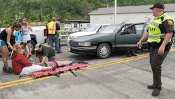 About  to  people were injured Saturday when a driver described by witnesses as an elderly man drove his car into a group of hikers marching in a parade in a small Virginia mountain town.