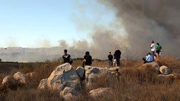 All evacuation orders were lifted at Camp Pendleton in Southern California, where firefighters gained ground on a wildfire that has burned nearly  square miles of dry brush.