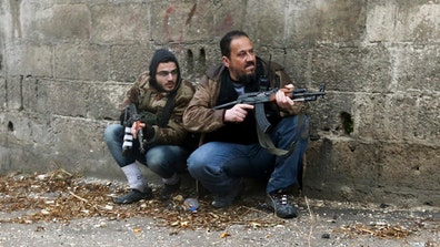 WARNING: GRAPHIC IMAGES: Goran Tomasevic, a photographer for Reuters, captured dramatic images of a rebel military mission in the Ain Tarma neighborhood of Damascus on Wednesday, Jan .