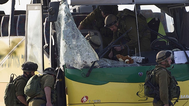 Soldier Examine Israel Bus After Attack AP
