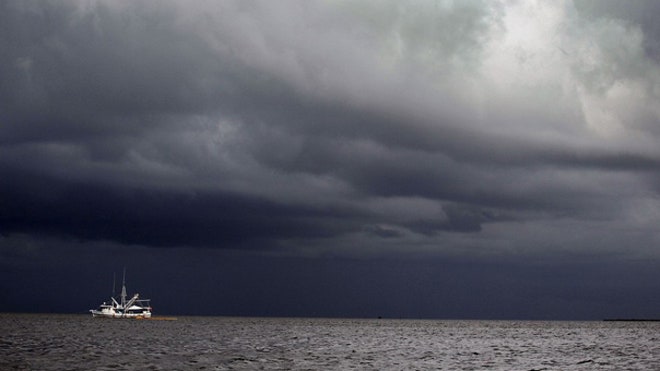 Stormy clouds over Gulf spill