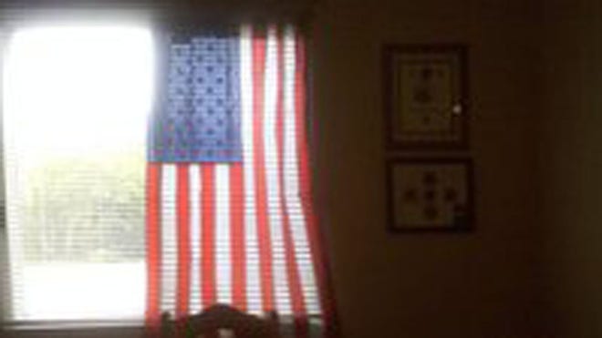 Charlie Price, 28, of Oshkosh, Wis., and officials at Midwest Realty Management have come to a "mutual agreement" that allows the veteran to continue displaying the patriotic symbol.