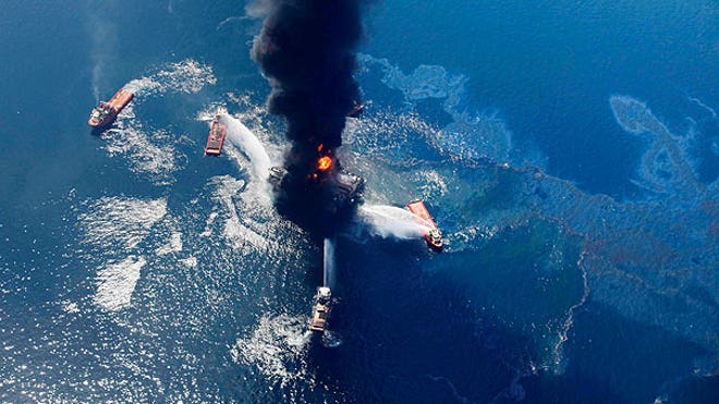 Oil slick grows as gulf rig burns