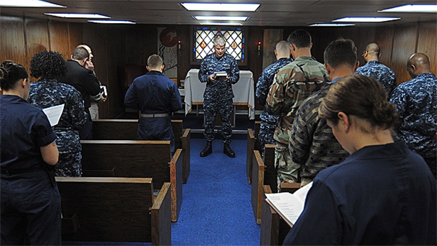 Navy Chaplain holding service U.S. Navy