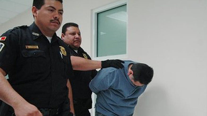 March 30: Police officers escort Ricardo Valles de la Rosa, right, to a court hearing in Ciudad Juarez, Mexico.