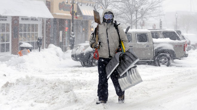 Man with snow shovels in Md.