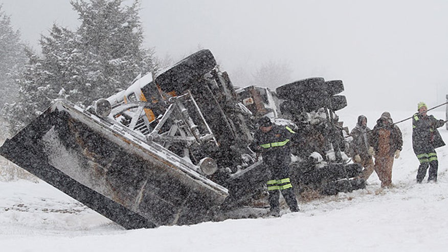 Snowplow flips in Kan storm