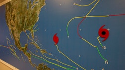 Hurricane Leslie marked time early Friday, spinning in place over the open Atlantic before resuming its northward advance toward the wealthy British territory of Bermuda.