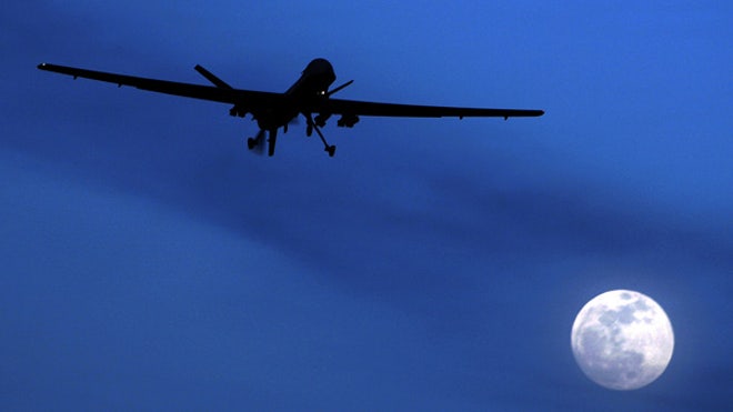 Predator drone flies next to moon