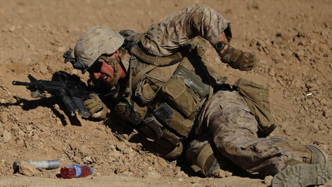 US Marine takes fire, reaches for ammo