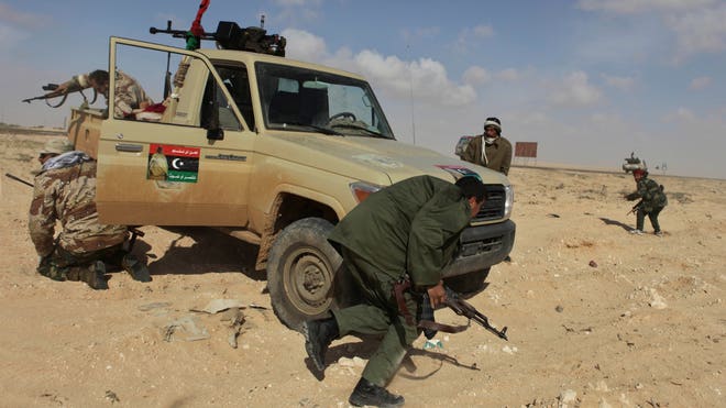 libya rebels run for cover