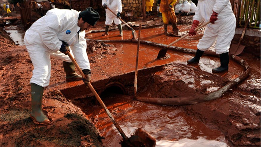 Workers Clean Street Flooded by Toxic Mud in Hungary