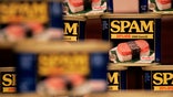 Citing weakness in its pork business, higher input costs and softer sales at its refrigerated foods unit, the Spam maker cut its full-year outlook.