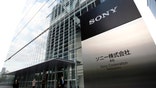 Sony cut sales targets for cameras, smartphones and tablets for the year as it assess a proposal from its biggest shareholder.