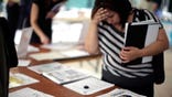 Jobless claims fell to ,in the latest week but remained close to levels linked with persistently high unemployment.