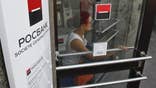The head of Societe Generale's  Russian unit Rosbank faced up to seven years in jail for bribery on Thursday after Russian investigators released a film of him with cash piled on his desk in what several bankers said may have been a set-up.