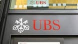 UBS AG lost a bid Tuesday to dismiss a whistle-blower lawsuit by a former commercial mortgage-backed securities strategist who said he was fired for refusing to publish misleading research reports.